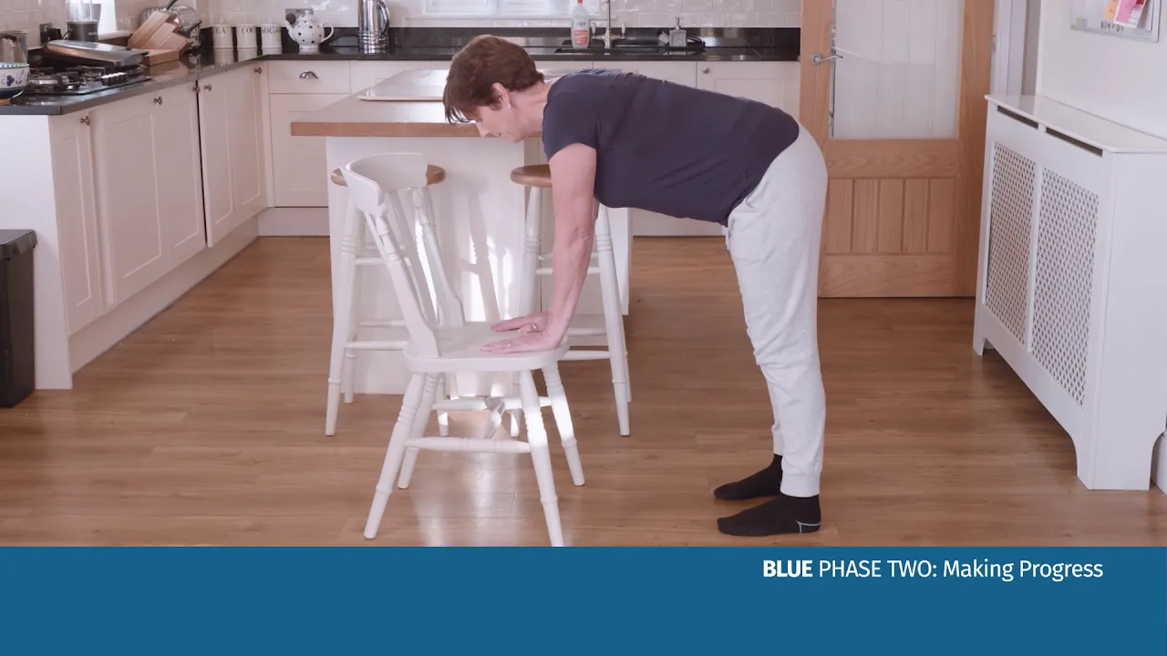 a man bending over a chair